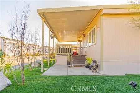 1134 Villa Calimesa Lane, Unit 42 Calimesa, CA 92320 - Photo 8 of 36 a view of a house with a yard and table and chair
