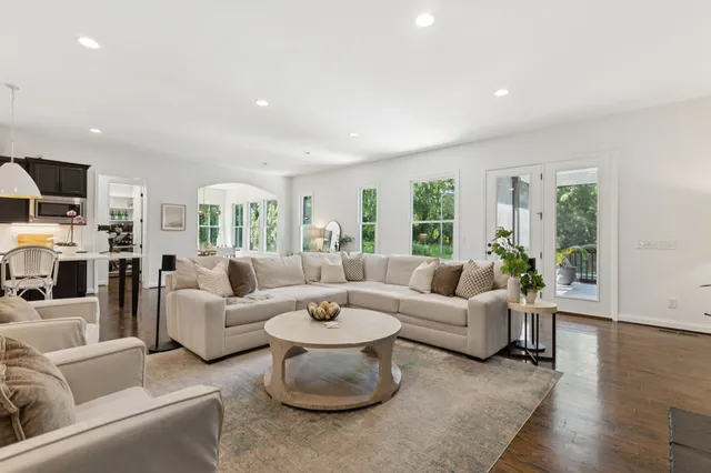 a kitchen with a sink a stove and chairs