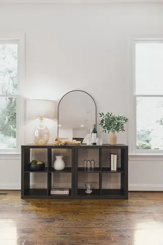 a living room with a fireplace a potted plant and a fireplace