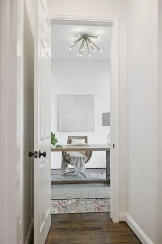 a living room with furniture a fireplace and a large window