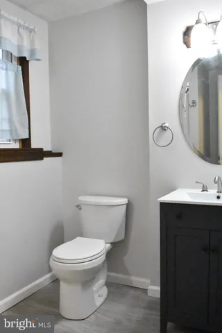 a white toilet sitting next to a bathroom sink