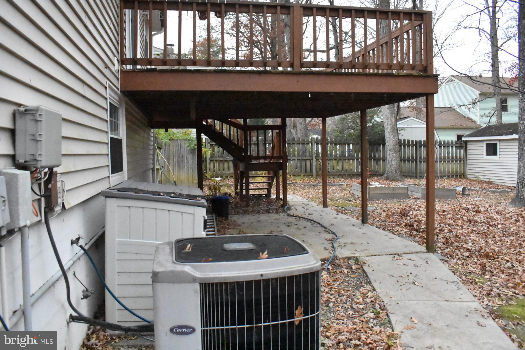 67 Devonne Drive Fredericksburg, VA 22407 - Photo 29 of 35 a view of a patio with table and chairs with wooden floor and fence and a floor to ceiling window