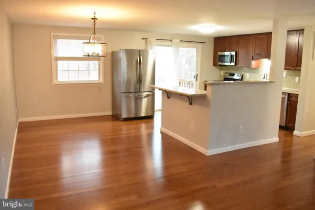 a kitchen with stainless steel appliances a refrigerator sink and microwave
