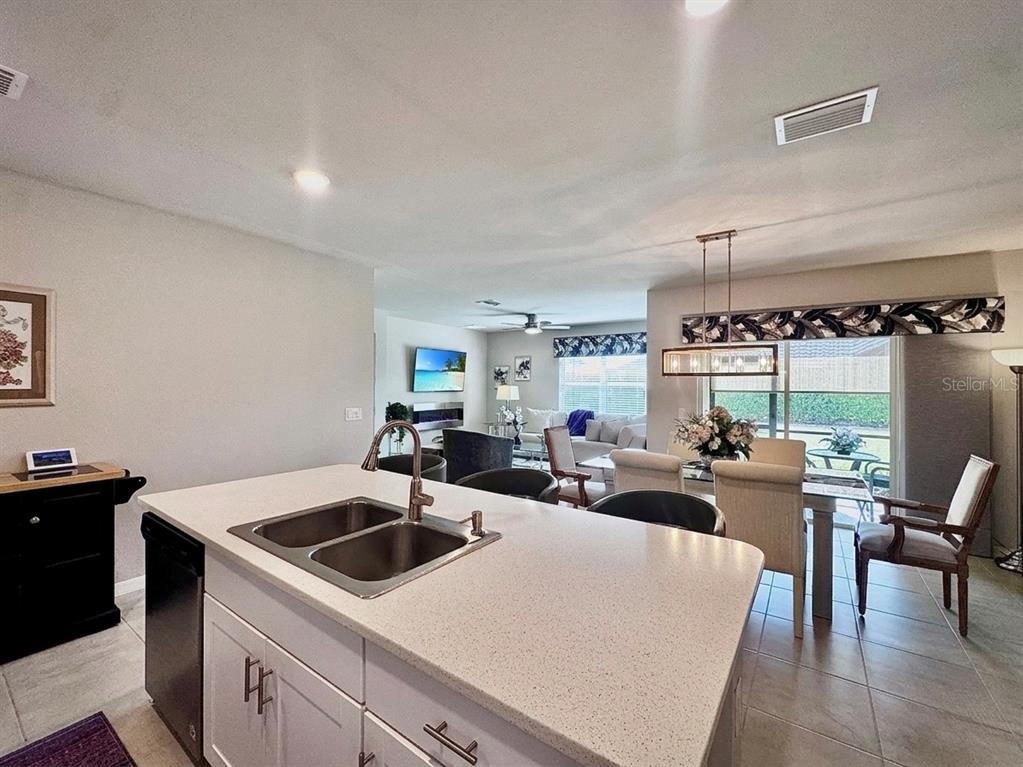 4077 Manatee Lane Punta Gorda, FL 33980 - Photo 15 of 35 a view of a kitchen with a stove a table and chairs in it