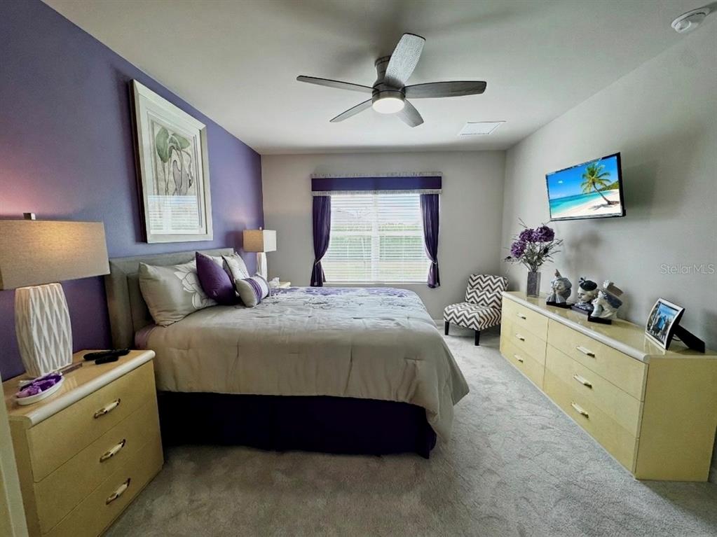4077 Manatee Lane Punta Gorda, FL 33980 - Photo 19 of 35 a bedroom with a bed and a dresser in it