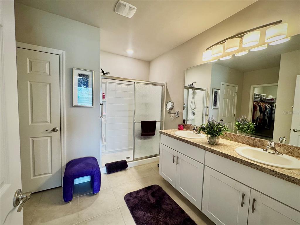 4077 Manatee Lane Punta Gorda, FL 33980 - Photo 20 of 35 a bathroom with a double vanity sink mirror and shower