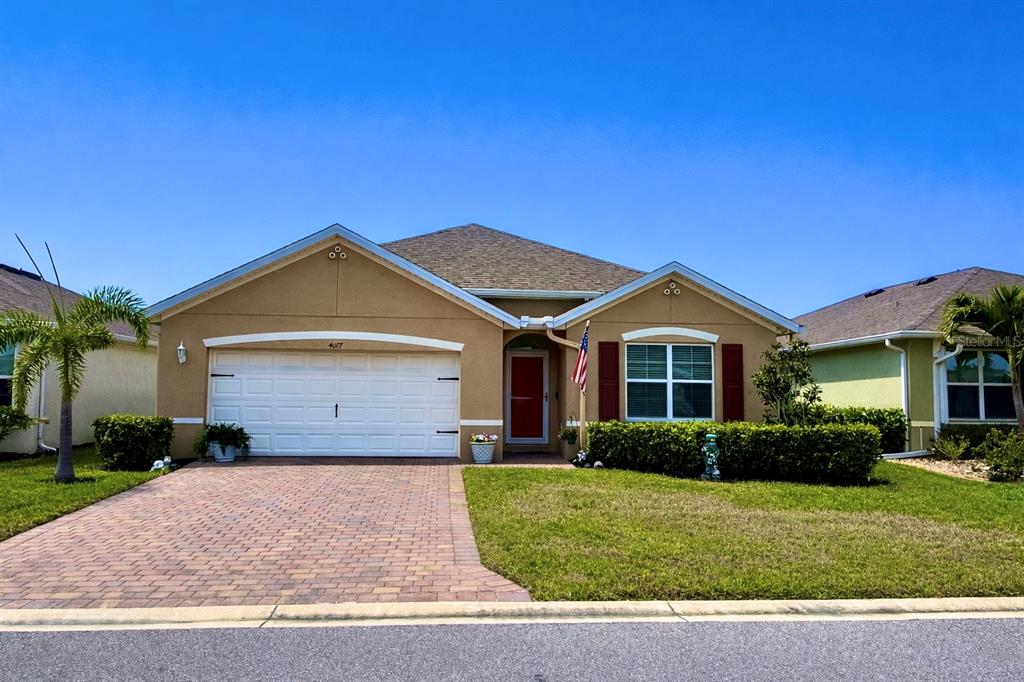 4077 Manatee Lane Punta Gorda, FL 33980 - Photo 2 of 35 a front view of a house with a yard and garage