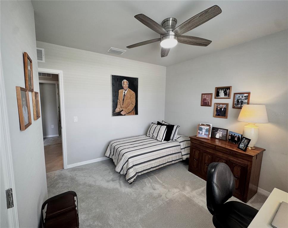 4077 Manatee Lane Punta Gorda, FL 33980 - Photo 26 of 35 a bedroom with a bed and a chandelier