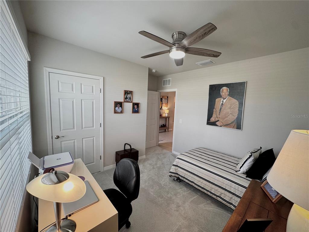 4077 Manatee Lane Punta Gorda, FL 33980 - Photo 27 of 35 a bedroom with furniture and a chandelier
