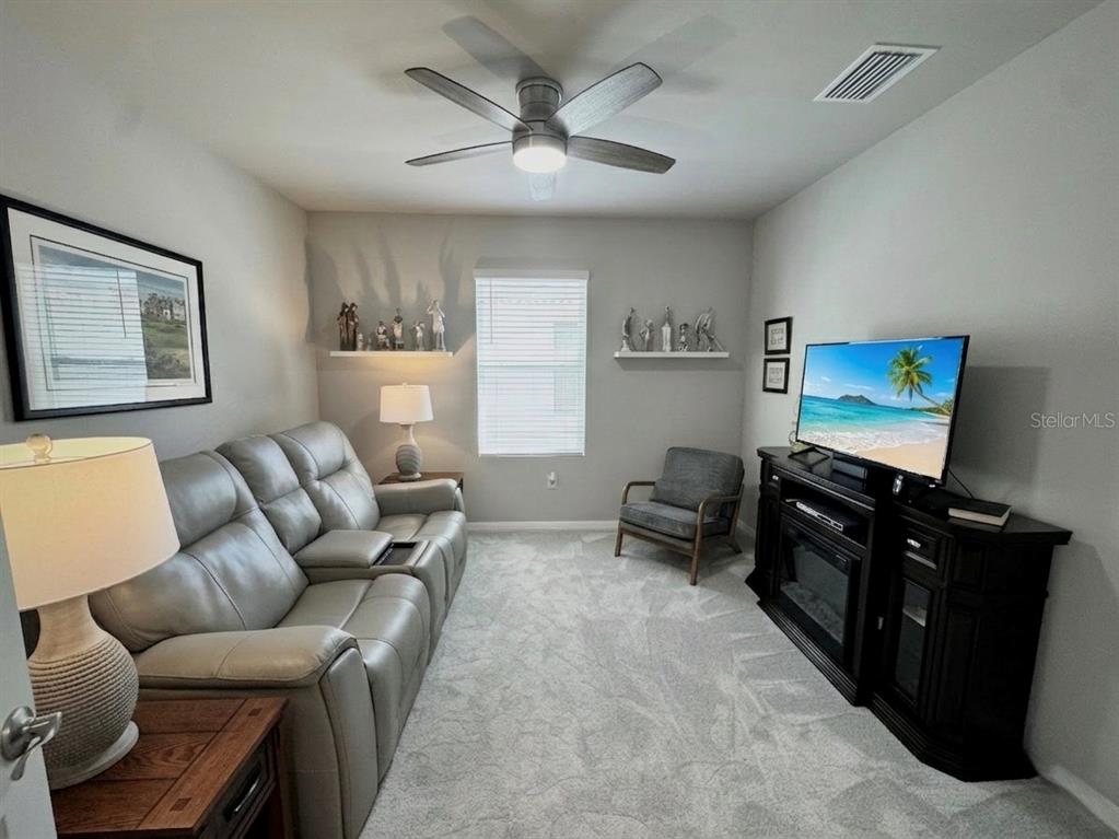 4077 Manatee Lane Punta Gorda, FL 33980 - Photo 29 of 35 a living room with furniture and a flat screen tv