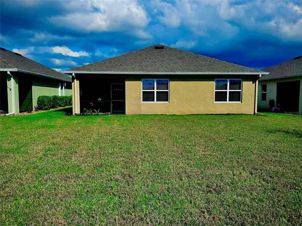 a view of a house with yard and a garden