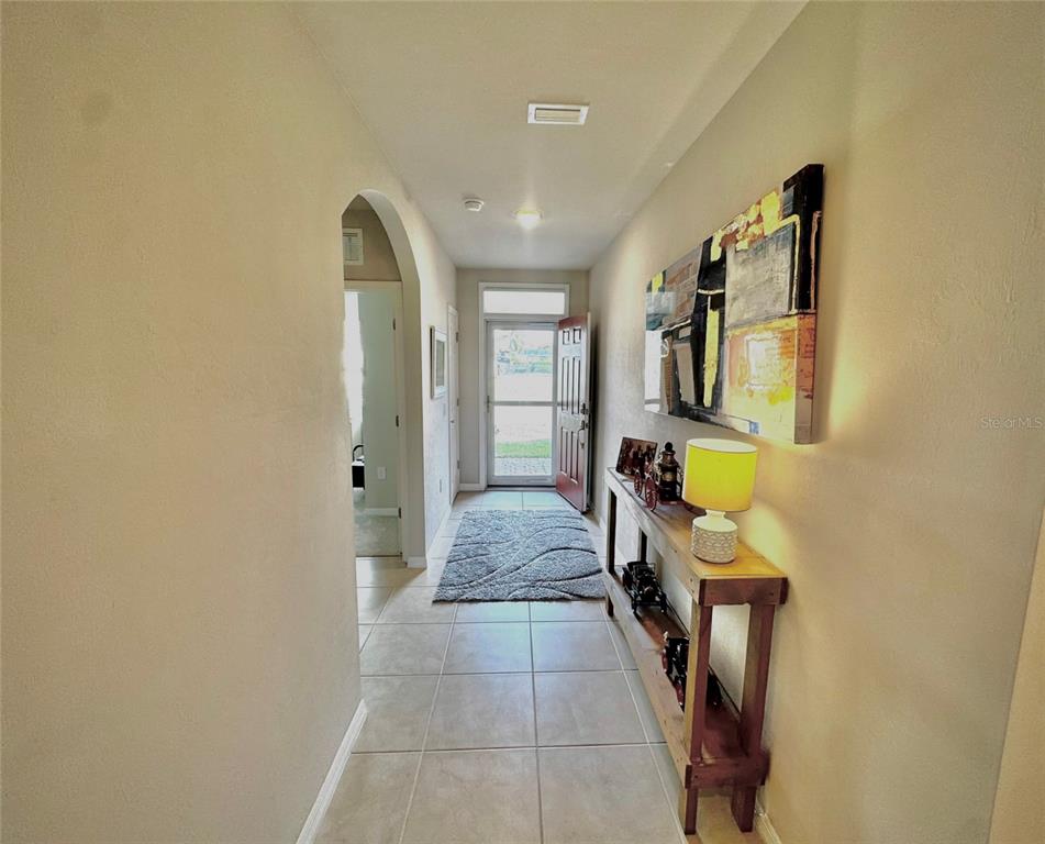 4077 Manatee Lane Punta Gorda, FL 33980 - Photo 7 of 35 a hallway with sliding door and couch