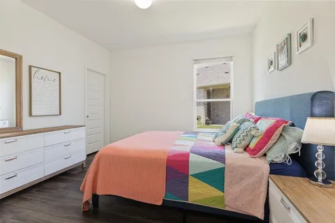 a bedroom with a bed and window