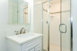 1 Stonehill Drive, Unit 3C Stoneham, MA 02180 - Photo 4 of 5 a bathroom with a sink shower and a mirror