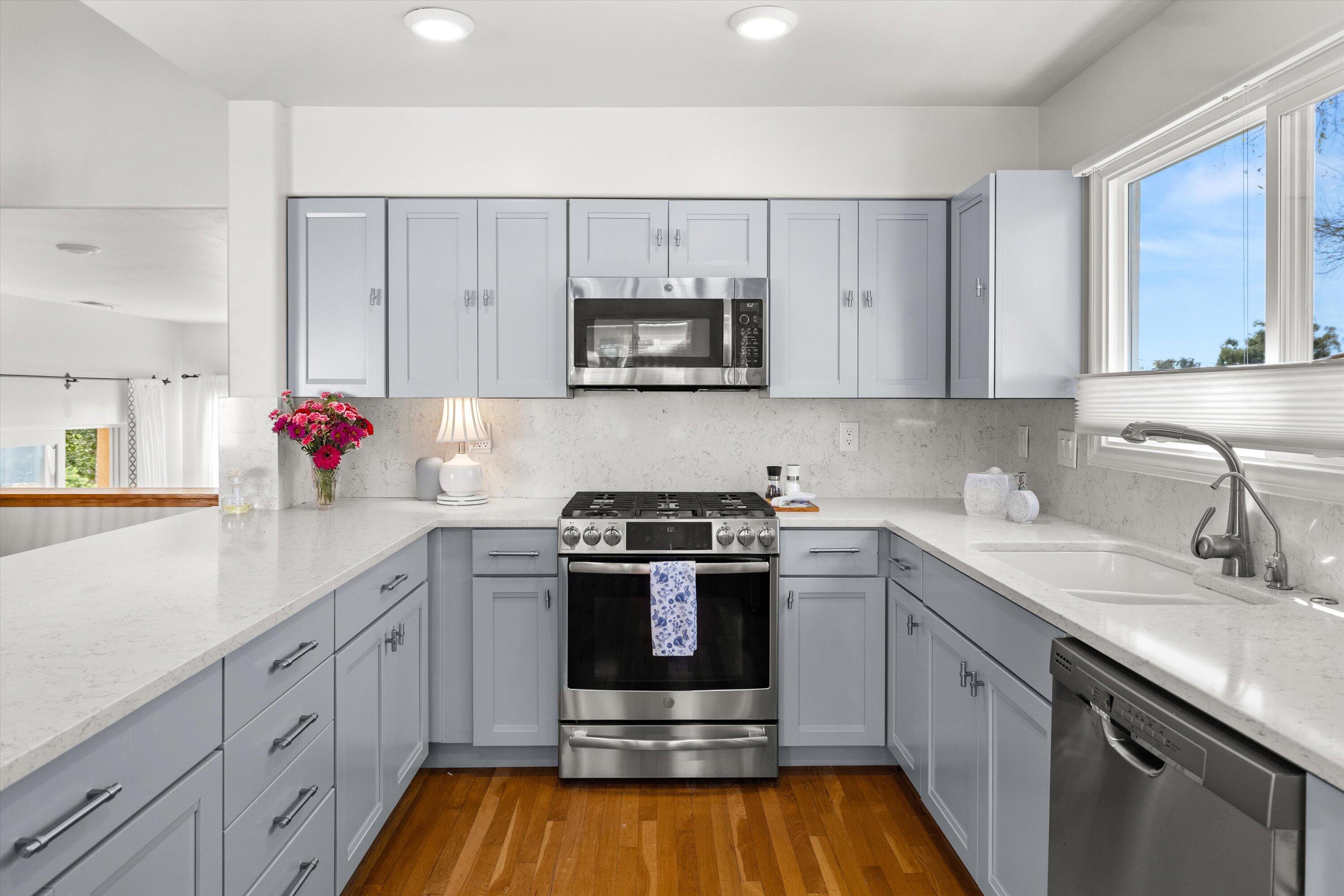 222 Meigs Road, Unit 16 Santa Barbara, CA 93109 - Photo 12 of 44 a kitchen with stainless steel appliances a sink cabinets and a wooden floor