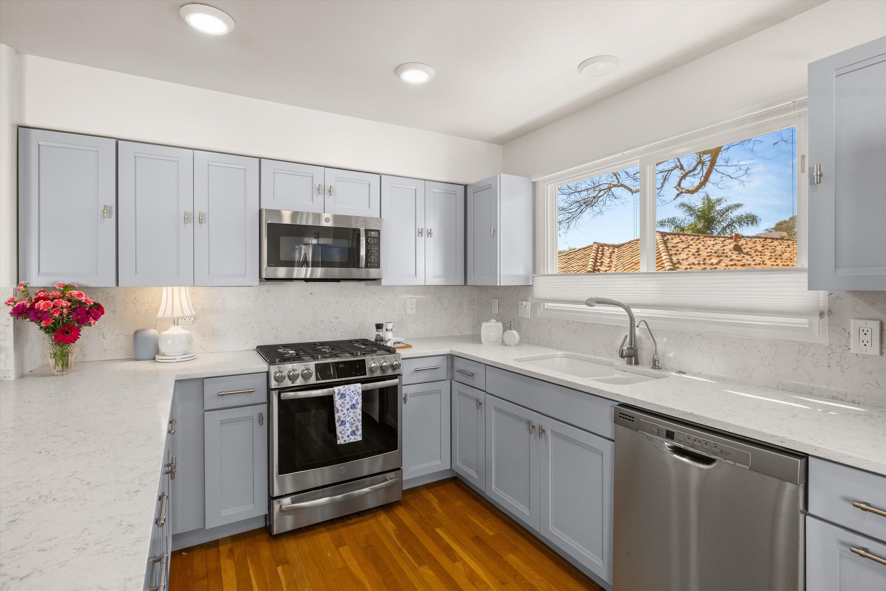 222 Meigs Road, Unit 16 Santa Barbara, CA 93109 - Photo 13 of 44 a kitchen with stainless steel appliances granite countertop a stove a sink and a microwave