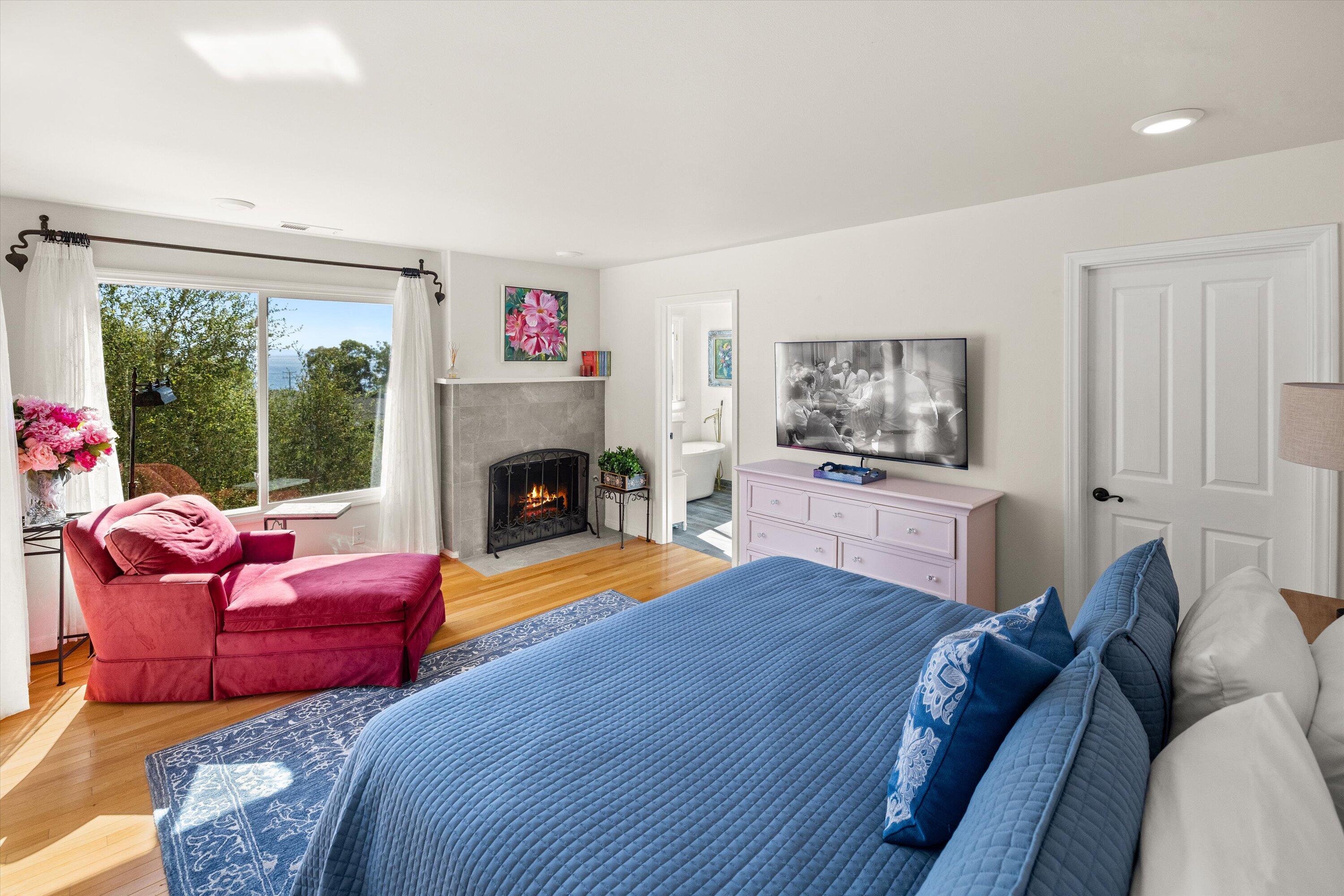 222 Meigs Road, Unit 16 Santa Barbara, CA 93109 - Photo 17 of 44 a bedroom with furniture and a fireplace
