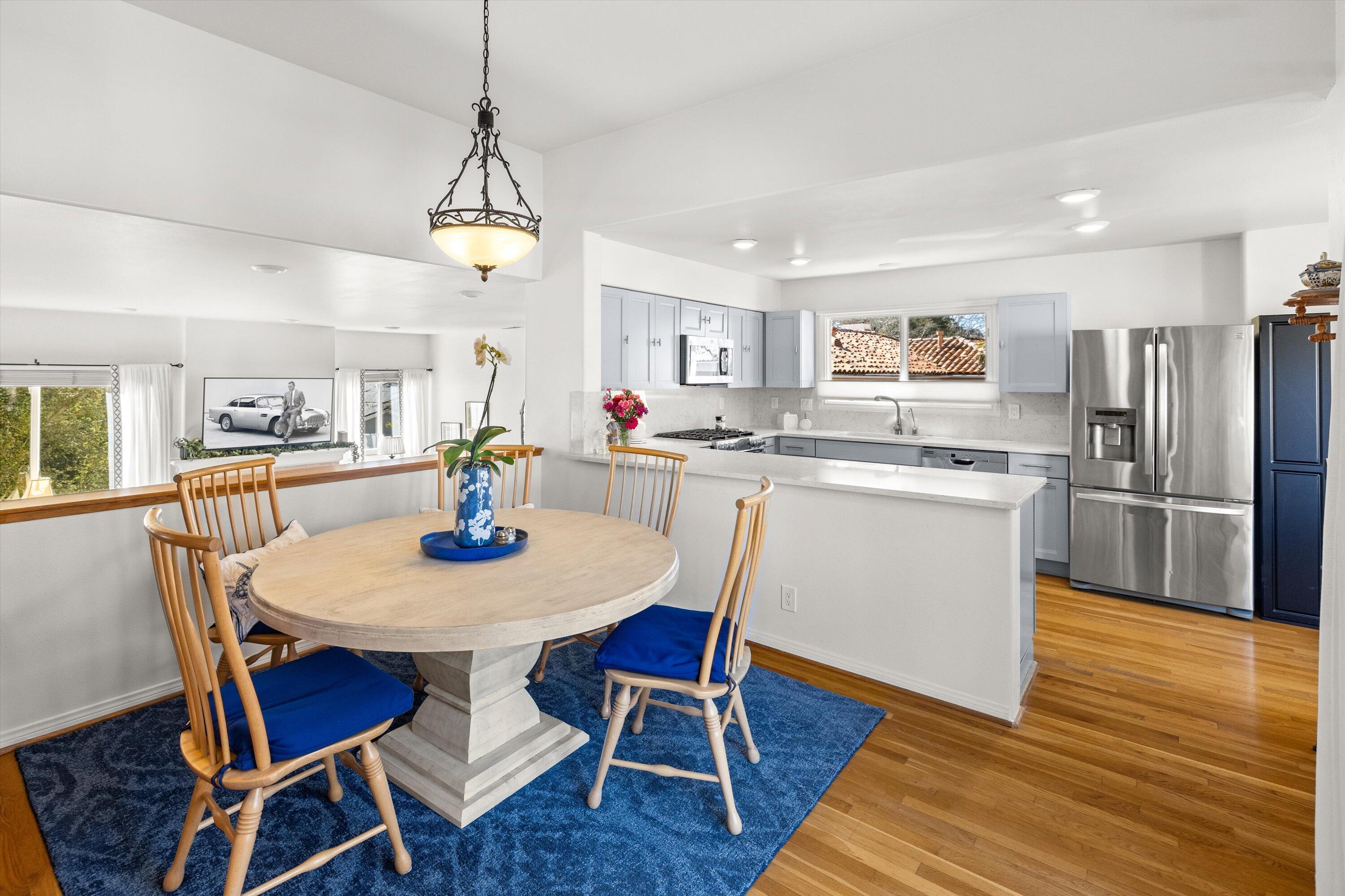222 Meigs Road, Unit 16 Santa Barbara, CA 93109 - Photo 9 of 44 a view of a dining room with furniture wooden floor and a chandelier