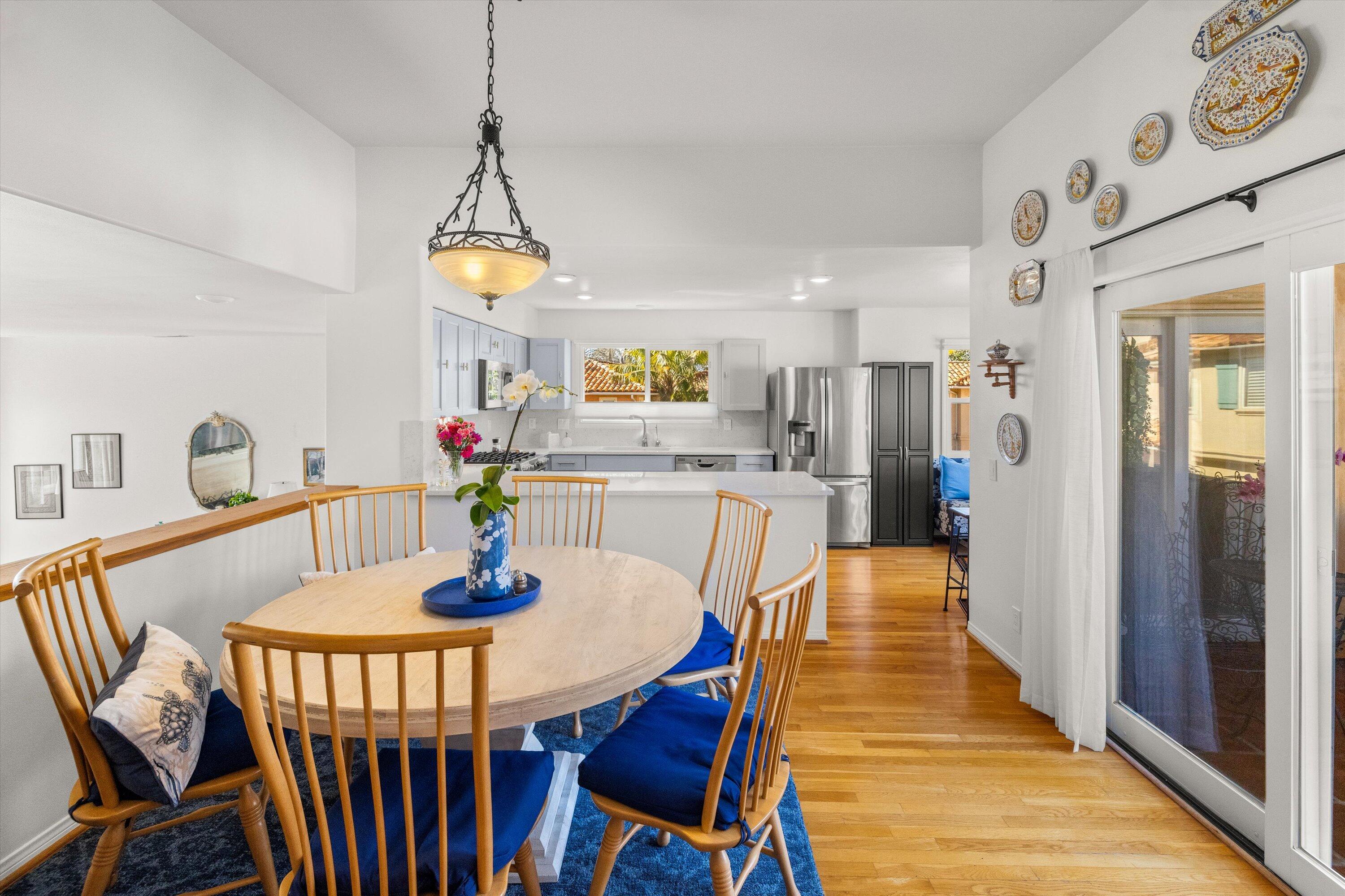 222 Meigs Road, Unit 16 Santa Barbara, CA 93109 - Photo 10 of 44 a dining room with furniture a chandelier and wooden floor