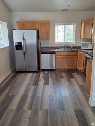 2159 Dakota Avenue Provo, UT 84606 - Photo 2 of 3 Kitchen featuring wood-finish flooring, oak cabinetry, stainless steel refrigerator, stainless steel dishwasher, and a double basin sink