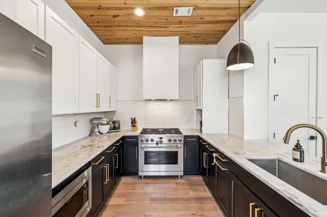 a kitchen with a sink stove and cabinets