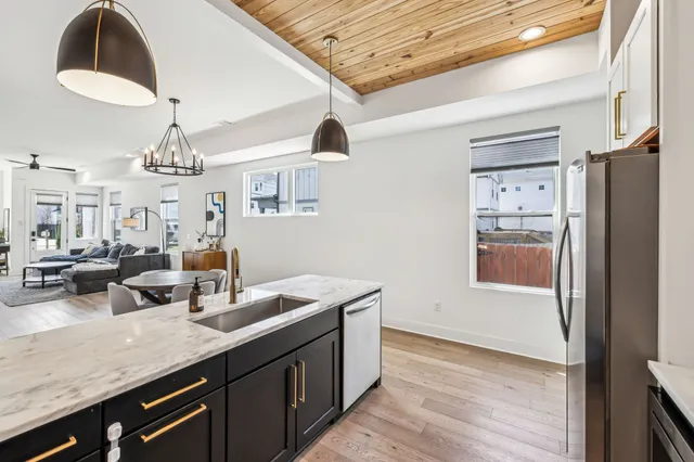 a kitchen with counter top space and wooden floor