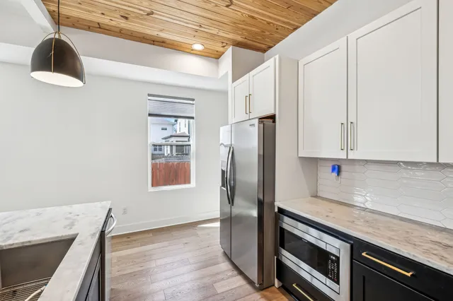 a kitchen with stainless steel appliances a refrigerator and a stove