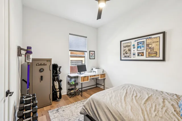 a bedroom with a bed and a desk