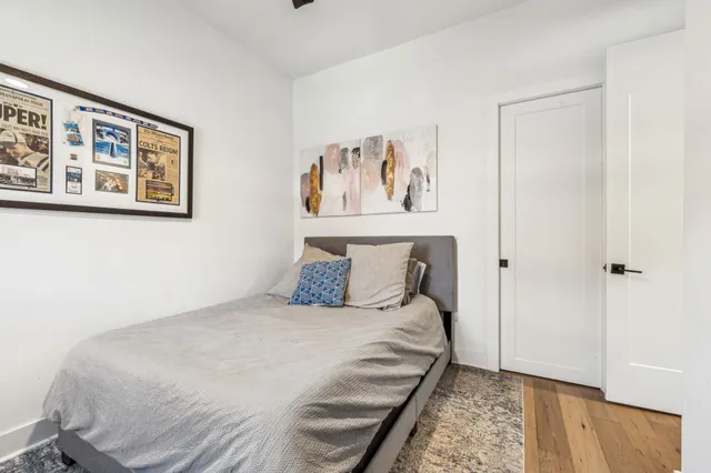 a bedroom with a bed and a wall painting