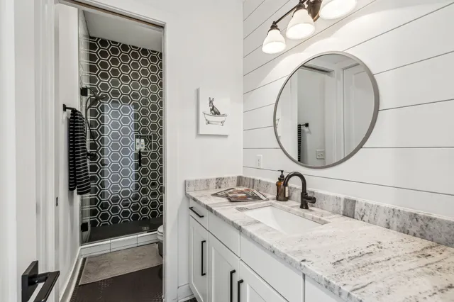a bathroom with a sink a vanity and a mirror