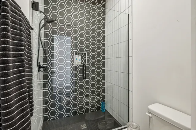 a bathroom with a shower and a toilet