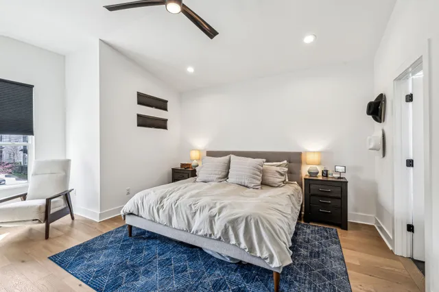 a bedroom with a bed and a chair