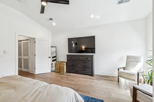 a bedroom with furniture and flat screen tv