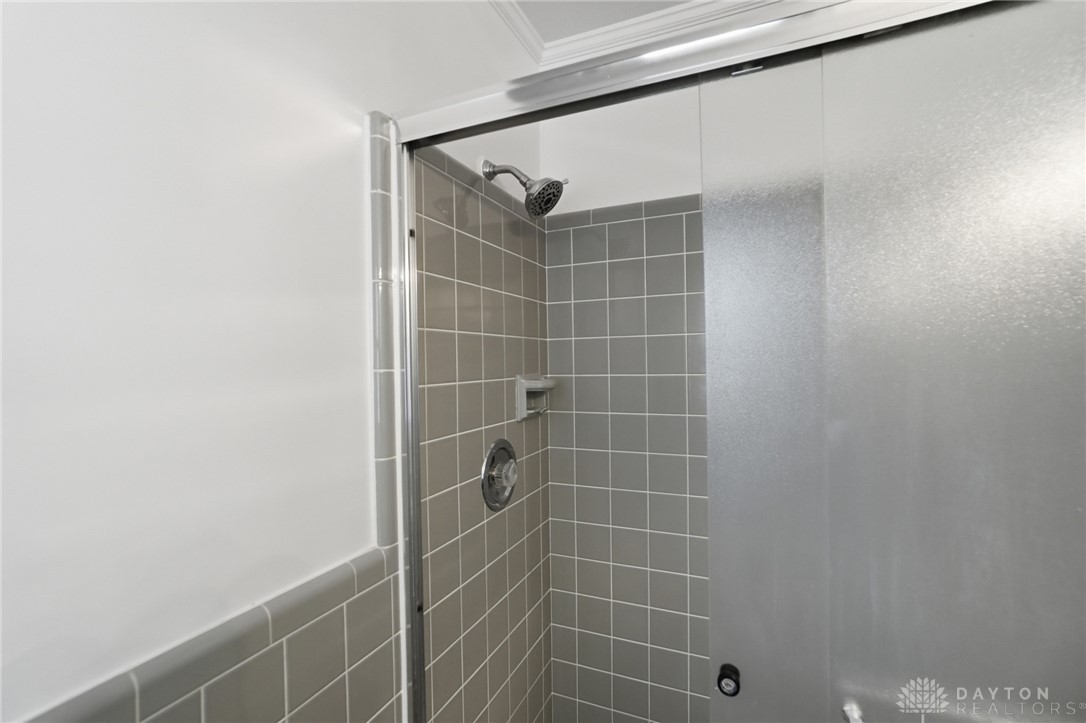 6119 Flemington Road Dayton, OH 45459 - Photo 30 of 76 This shower enclosure offers a refreshing and modern bathing experience with sleek tile walls.