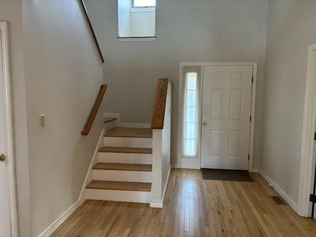 a view of entryway with wooden floor