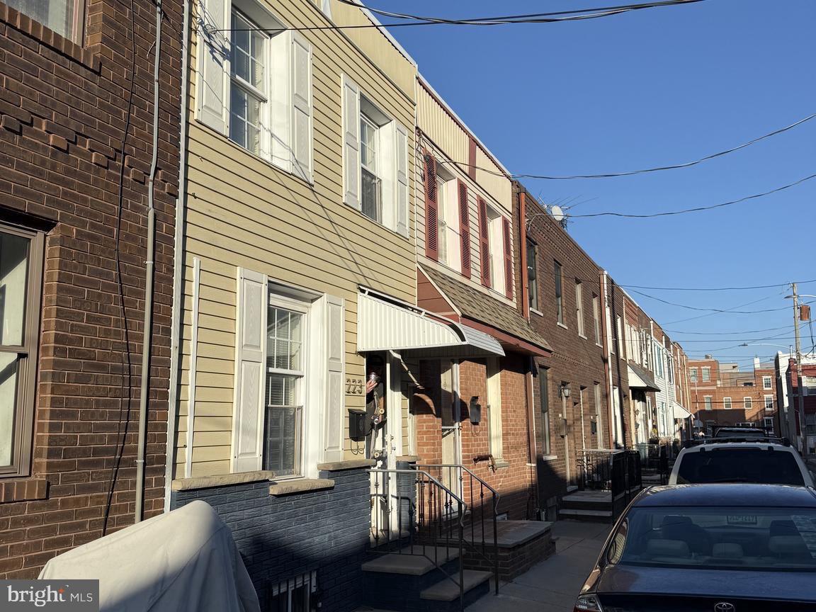 a front view of a house with outdoor seating