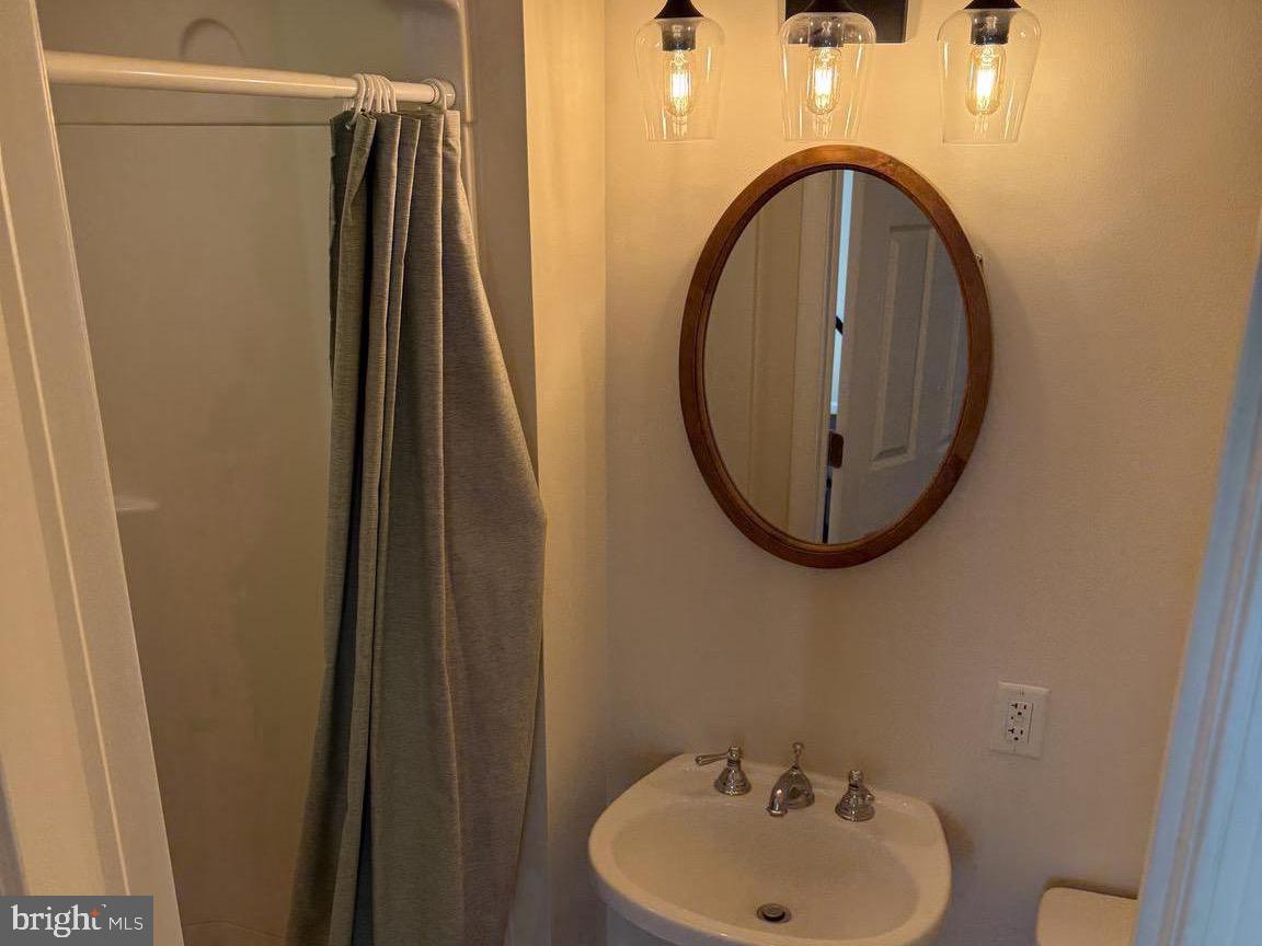 223 Gerritt Street Philadelphia, PA 19147 - Photo 8 of 10 a bathroom with a sink and a mirror
