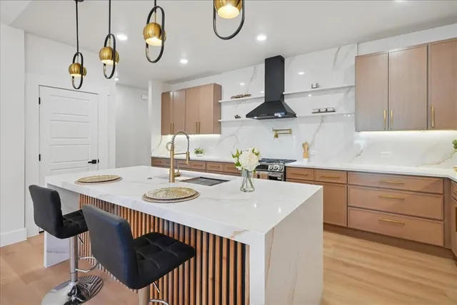 a kitchen with a sink cabinets and wooden floor