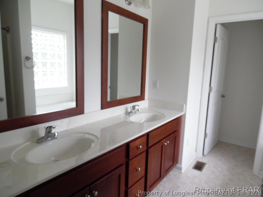 76 Ithica Lane Bunnlevel, NC 28323 - Photo 17 of 35 a bathroom with a double vanity sink and a mirror