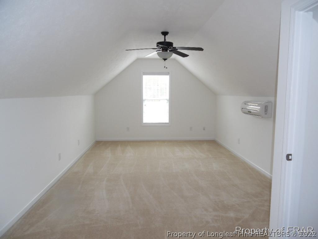 76 Ithica Lane Bunnlevel, NC 28323 - Photo 32 of 35 an empty room with a window and a chandelier fan