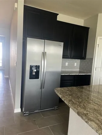 a kitchen with a refrigerator and a sink