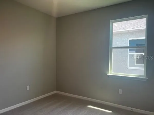 a white toilet sitting next to a white wall