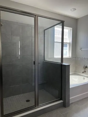 a view of kitchen with stainless steel appliances a refrigerator and a microwave