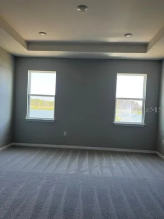 a kitchen with kitchen island stainless steel appliances a sink a counter top space cabinets and a window