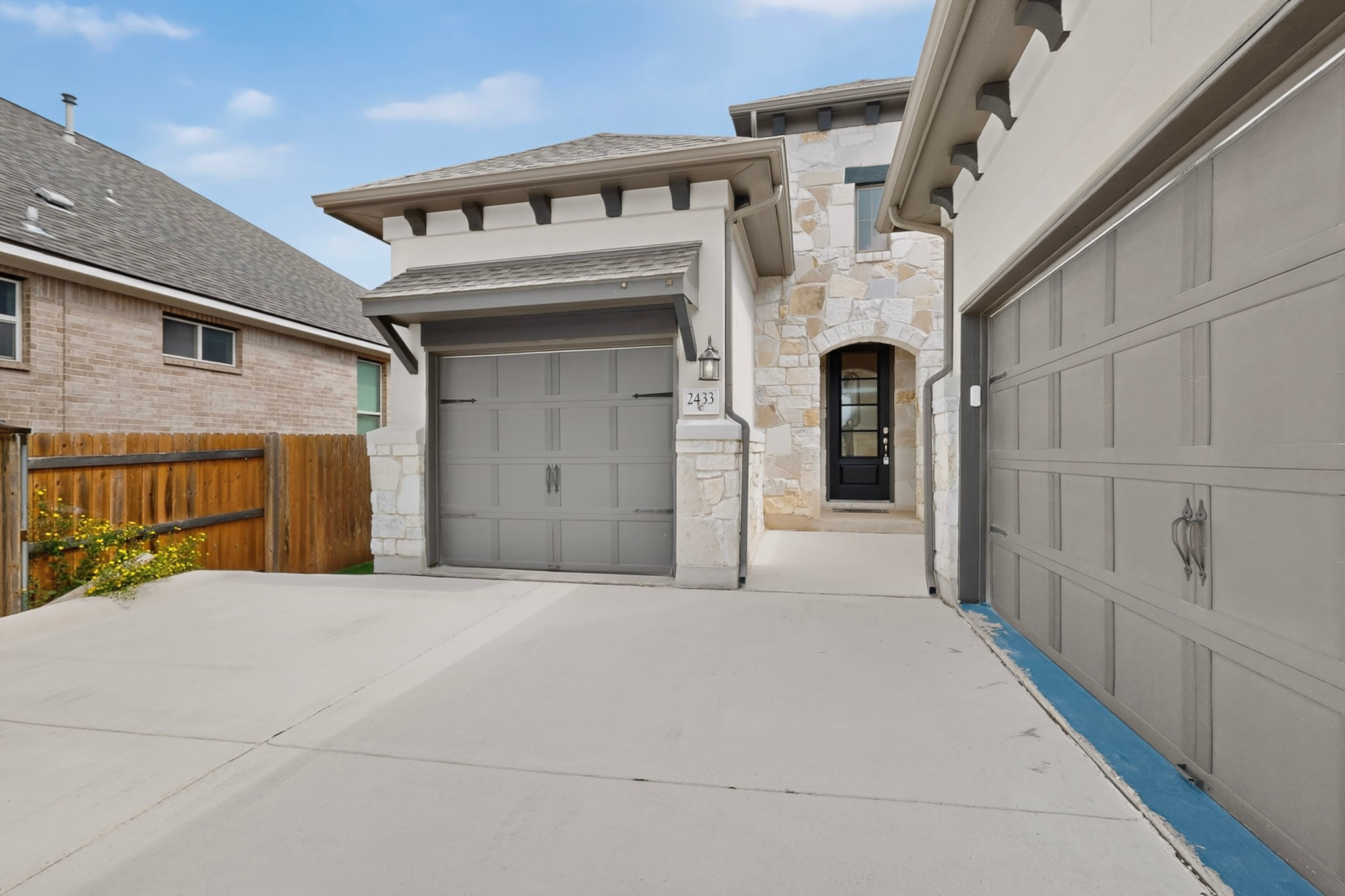 2433 La Mirada Street Leander, TX 78641 - Photo 3 of 25 A stone and stucco facade with dual garages welcomes you to this charming residence.