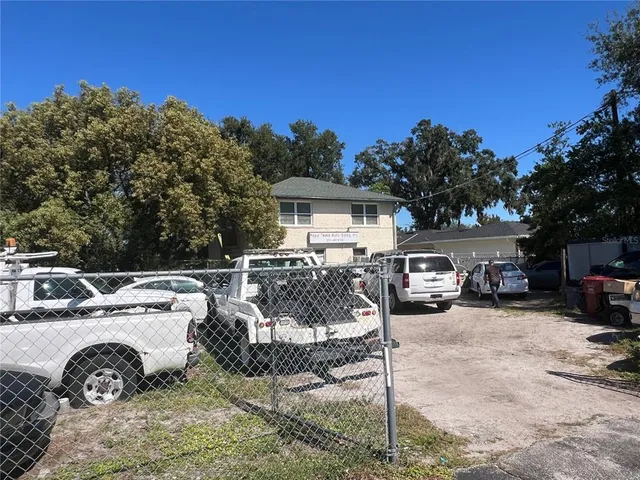 a view of a town with barn house in the background