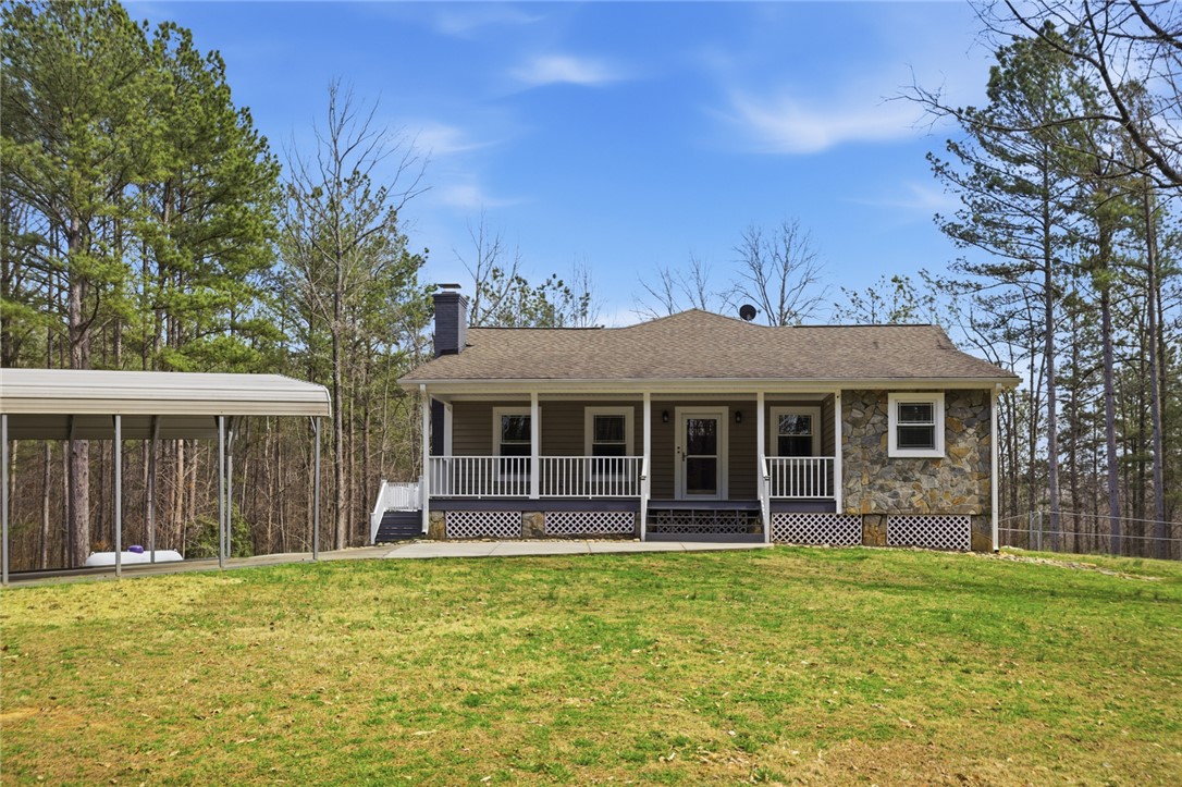 196 Flyroot Trail Pickens, SC 29671 - Photo 34 of 48 This charming home features a welcoming porch and a practical carport, nestled in a serene, wooded setting.