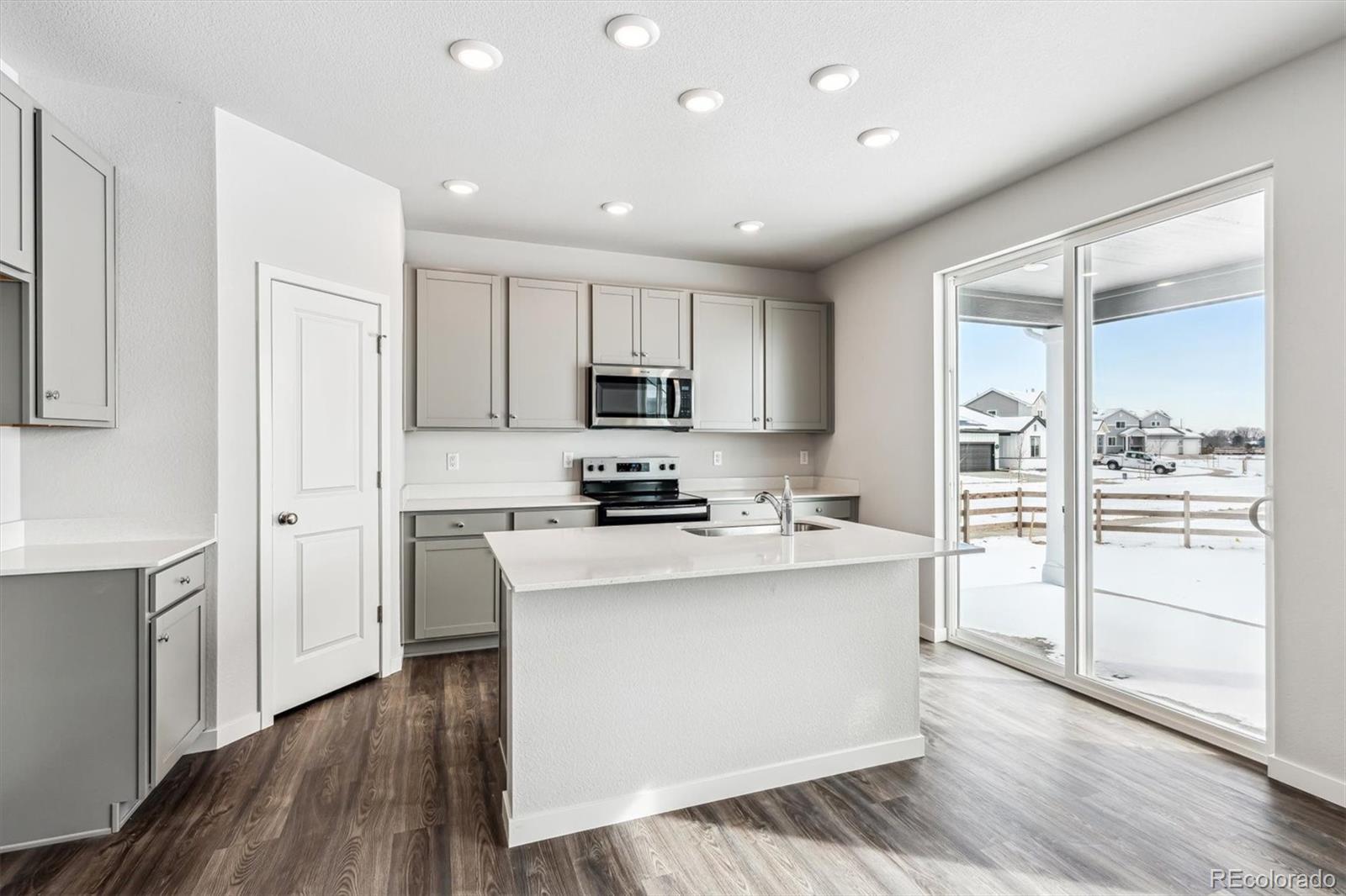 5680 Ranch Street Mead, CO 80504 - Photo 6 of 23 a kitchen with cabinets and wooden floor