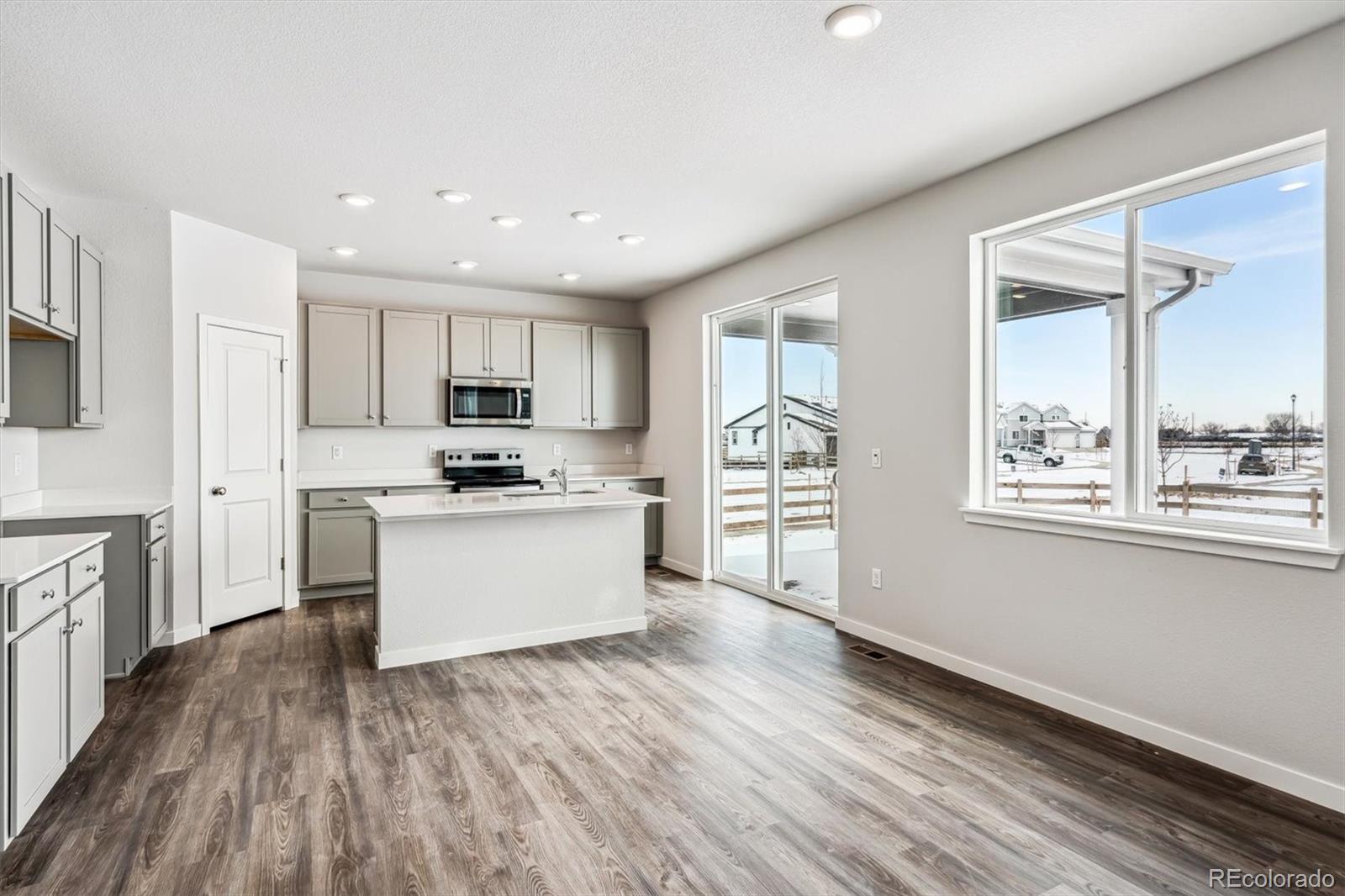 5680 Ranch Street Mead, CO 80504 - Photo 7 of 23 a kitchen with white cabinets and appliances