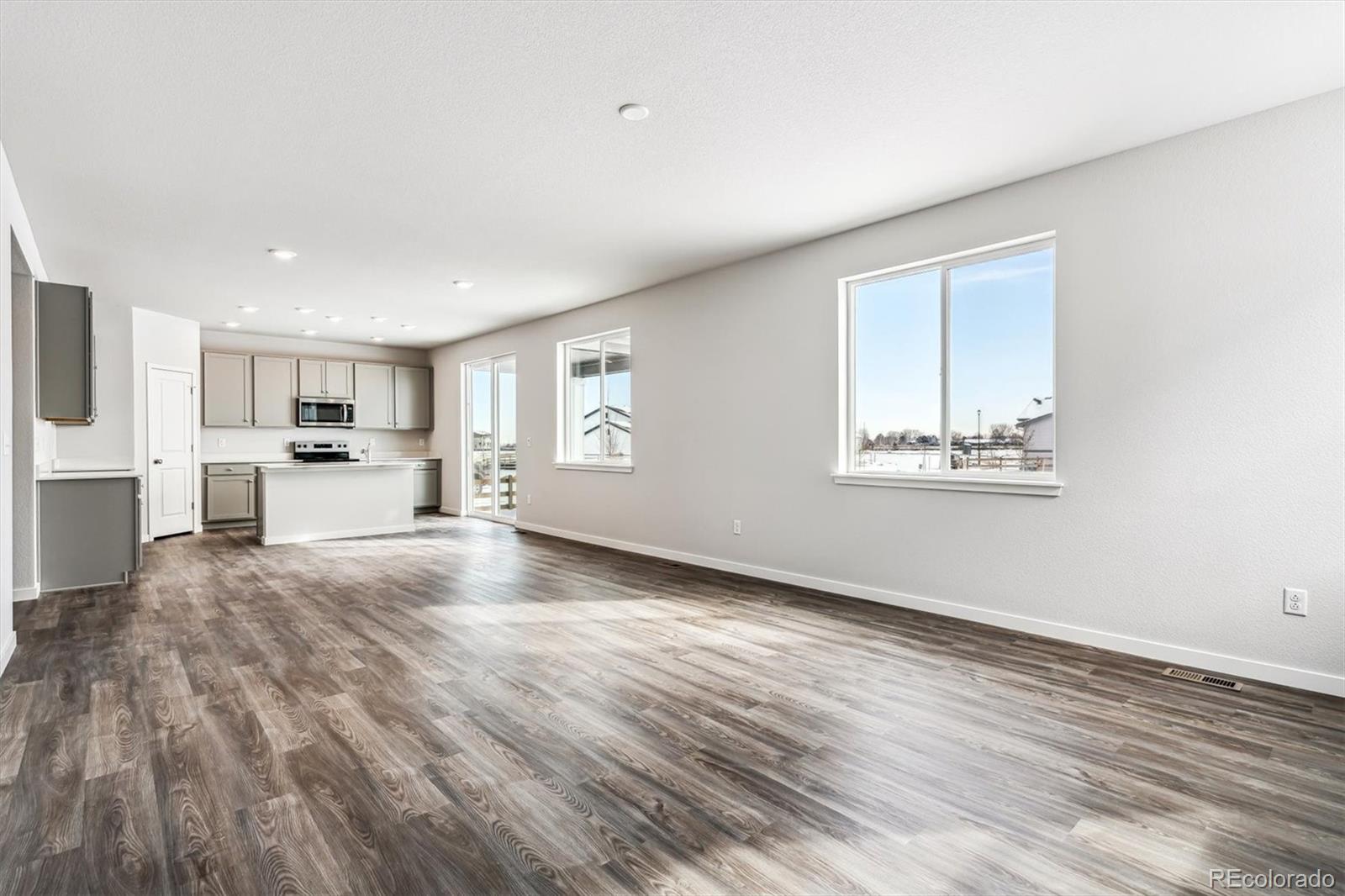 5680 Ranch Street Mead, CO 80504 - Photo 8 of 23 a view of kitchen and hall with wooden floor